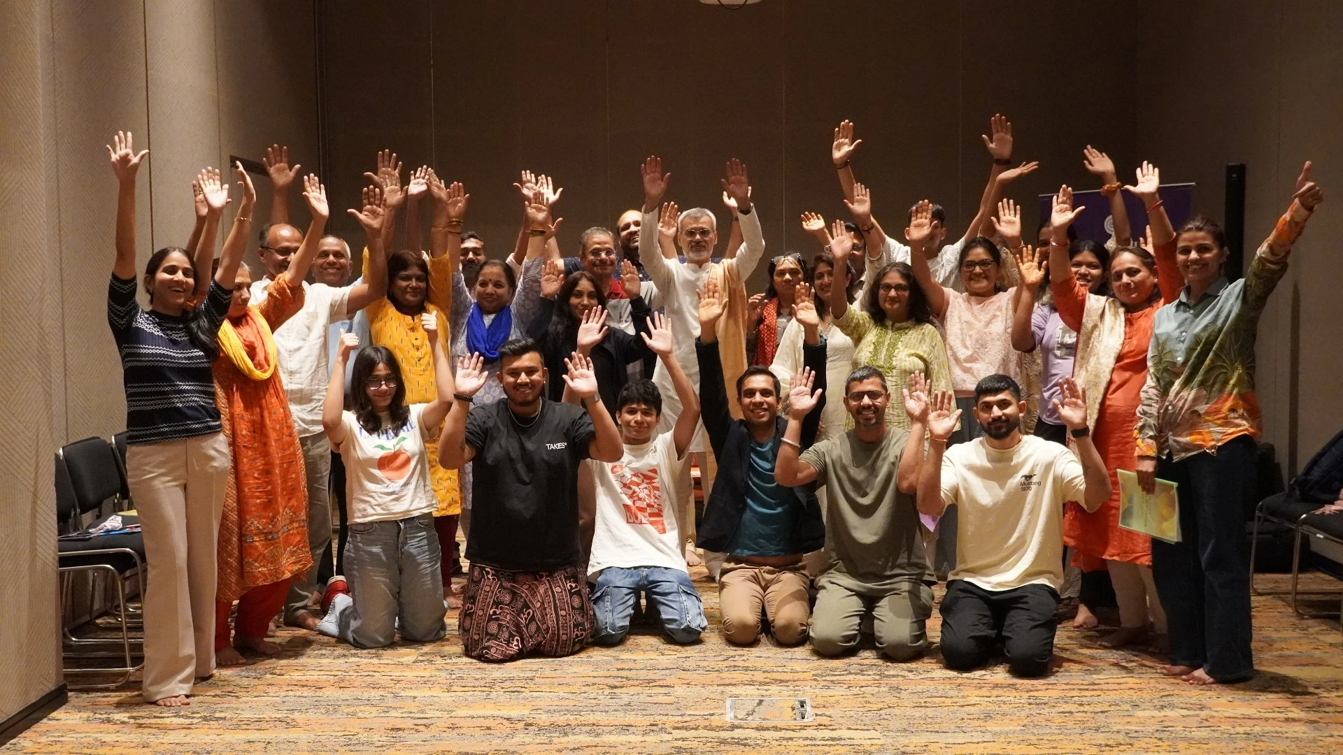 Wellness Vibe workshop group photo, hands raised